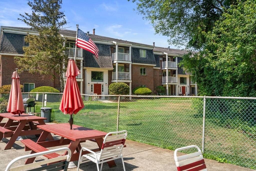 47 Will Drive, Unit 114 Canton, MA 02021 - Photo 24 of 25 a view of a house with a yard and sitting area