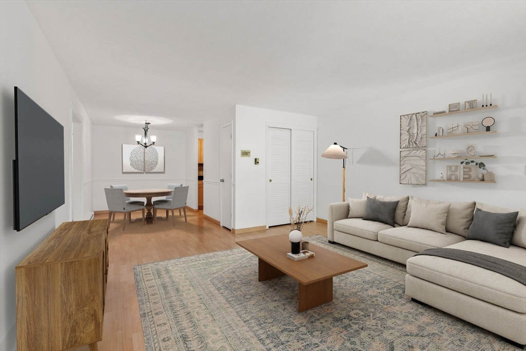 47 Will Drive, Unit 114 Canton, MA 02021 - Photo 3 of 25 a living room with furniture and a flat screen tv