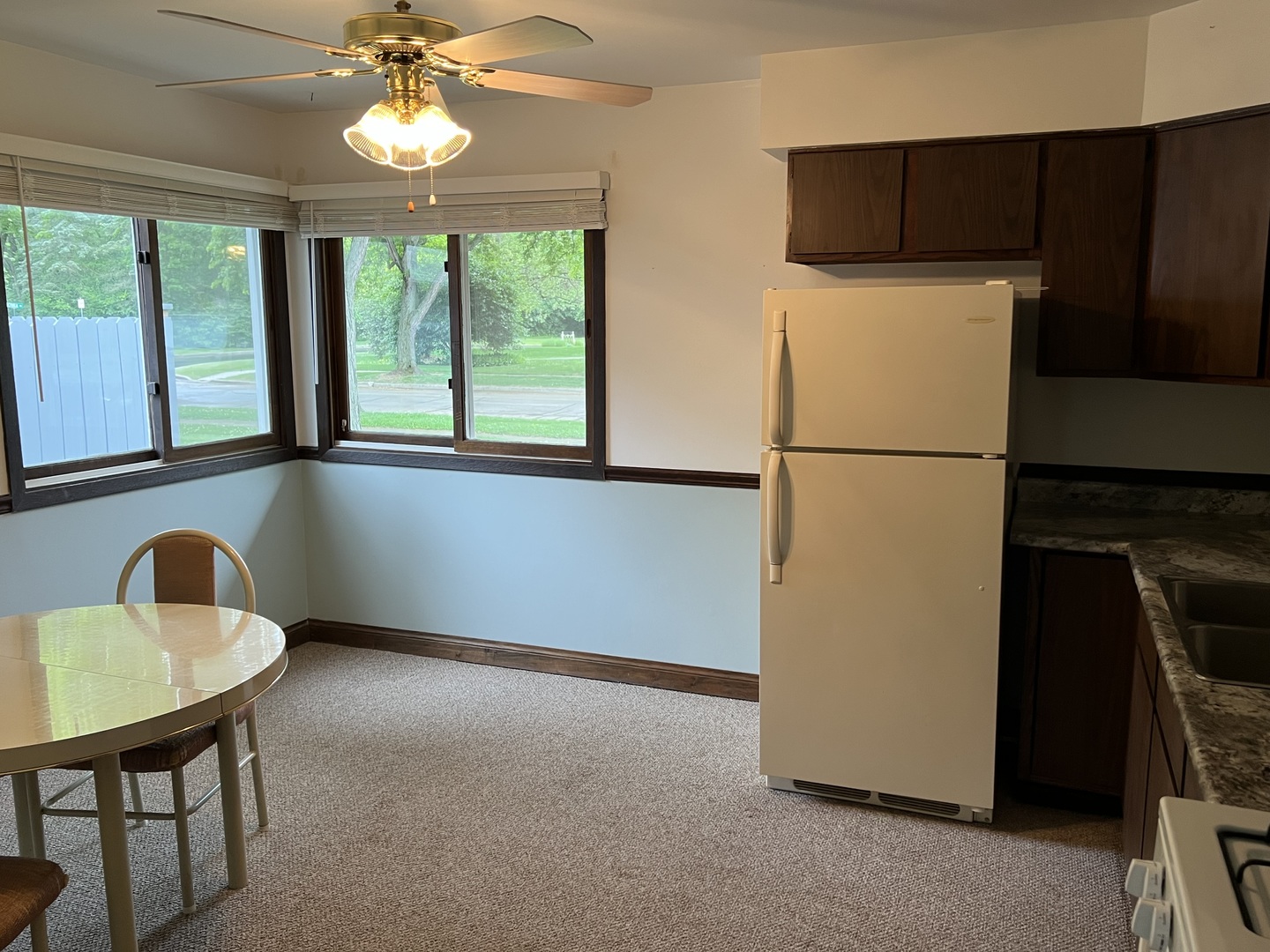 1214 Thomas Drive Woodstock, IL 60098 - Photo 12 of 14 a kitchen with a refrigerator a stove and a window