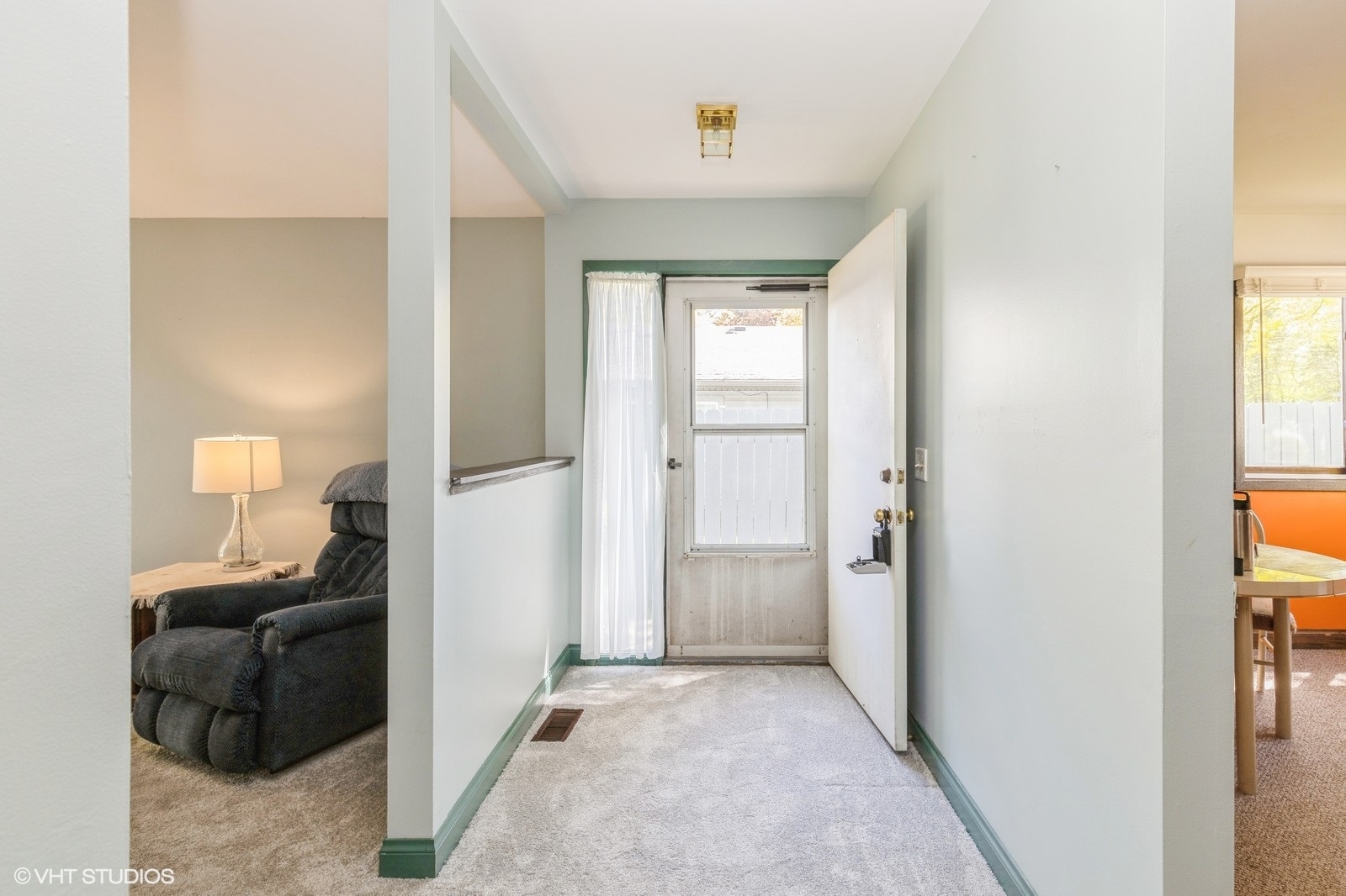 1214 Thomas Drive Woodstock, IL 60098 - Photo 4 of 14 a view of a livingroom with a closet and mirror