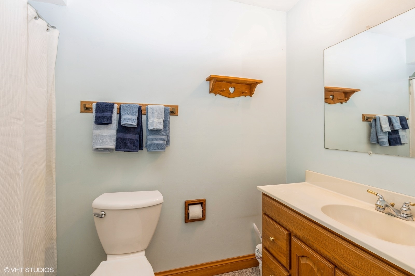 1214 Thomas Drive Woodstock, IL 60098 - Photo 8 of 14 a bathroom with a toilet sink and mirror