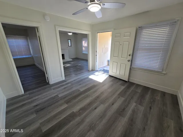 wooden floor in an empty room with a mirror