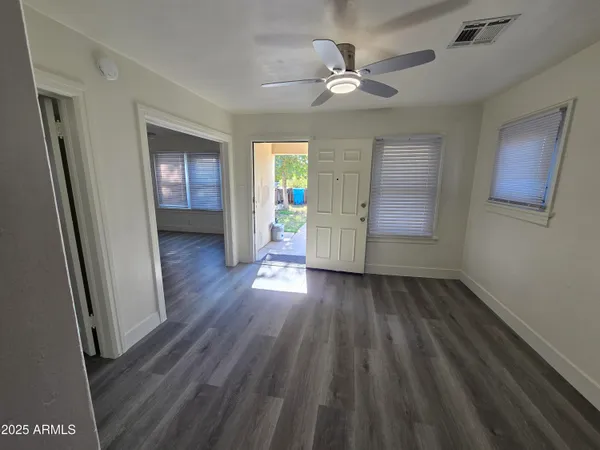 wooden floor in an empty room with a window