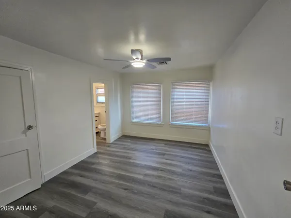 a kitchen with stainless steel appliances a refrigerator and wooden floor