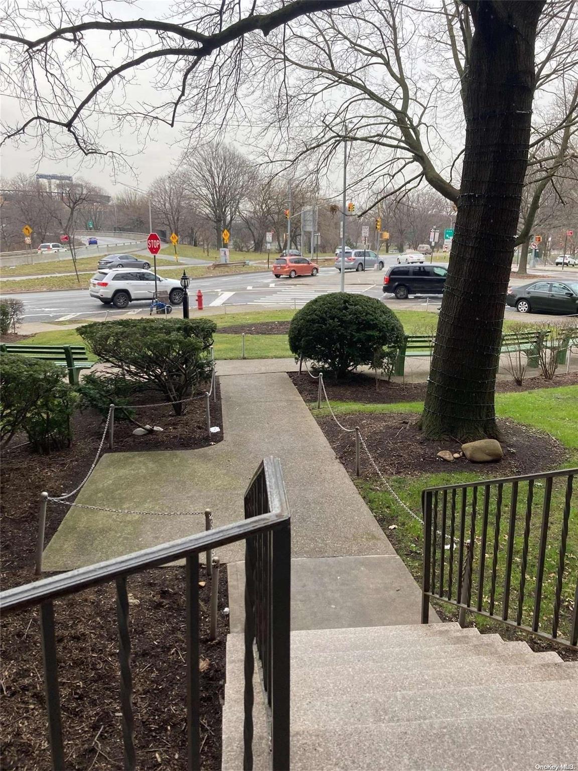 a view of a street with a car parked beside