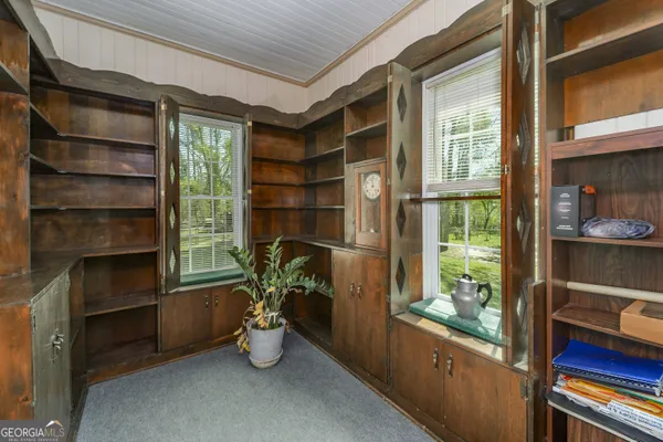 a kitchen with stainless steel appliances granite countertop a stove top oven a sink dishwasher a dining table and chairs with wooden floor