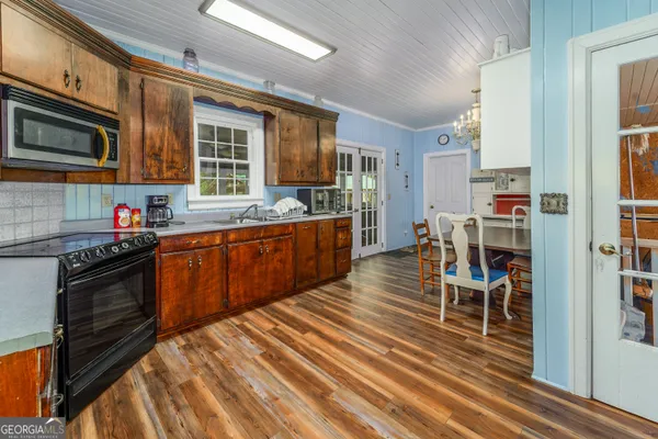 a kitchen with stainless steel appliances granite countertop a refrigerator stove microwave and sink