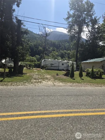 a view of a yard with wooden fence