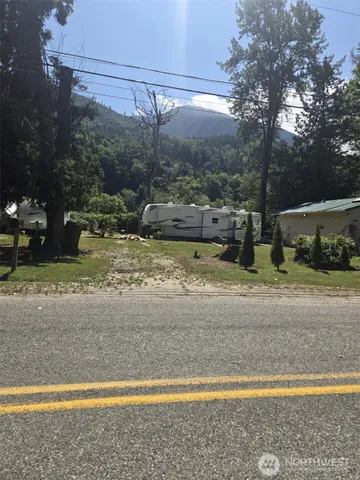 a view of a yard with wooden fence