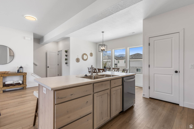 636 West Caroles Way, Unit 7 Tooele, UT 84074 - Photo 13 of 31 Kitchen island with double basin sink, integrated dishwasher, and light wood-finish cabinetry