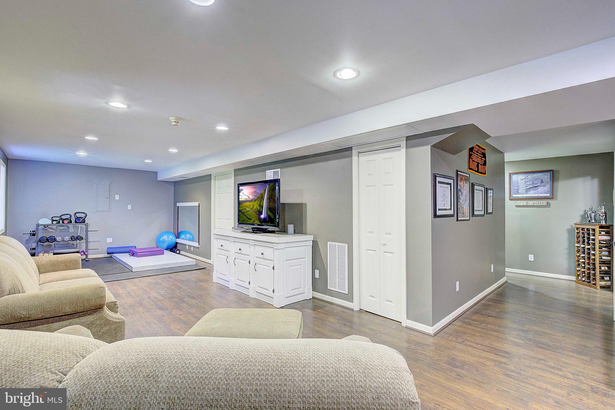 205 Walnut Creek Road Huntingtown, MD 20639 - Photo 33 of 48 a living room with furniture and a flat screen tv