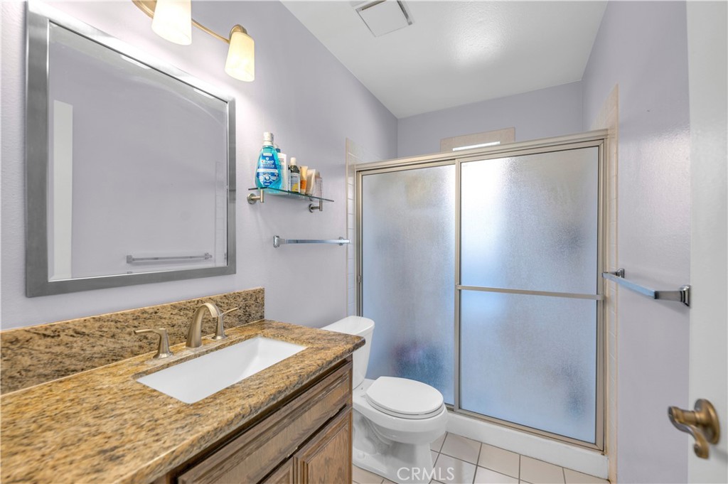 1114 Bottle Tree Way Hemet, CA 92545 - Photo 15 of 25 a bathroom with a granite countertop sink toilet and shower