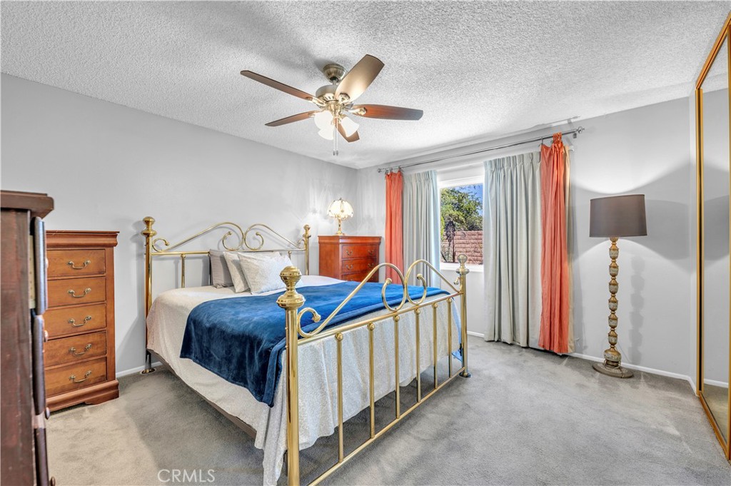 1114 Bottle Tree Way Hemet, CA 92545 - Photo 16 of 25 a bedroom with a bed and a chandelier