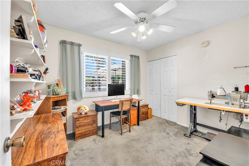 1114 Bottle Tree Way Hemet, CA 92545 - Photo 18 of 25 a view of a workspace with furniture and a window