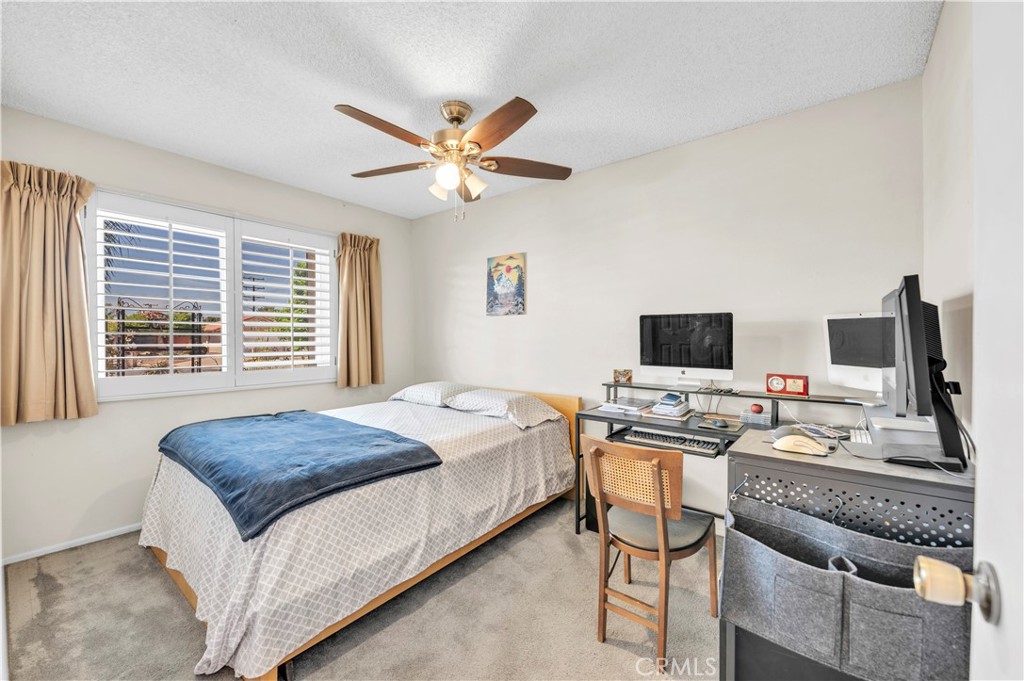 1114 Bottle Tree Way Hemet, CA 92545 - Photo 19 of 25 a bedroom with a bed and a flat screen tv