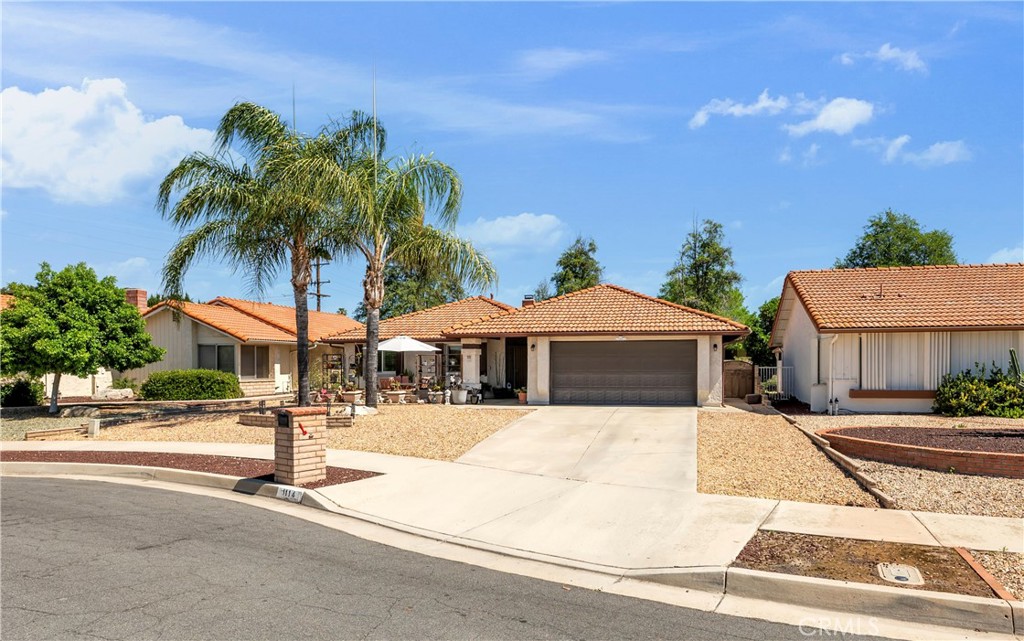 1114 Bottle Tree Way Hemet, CA 92545 - Photo 2 of 25 a view of a street with palm trees