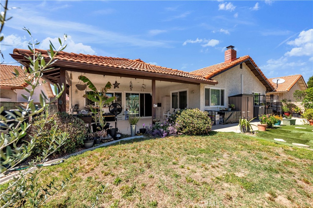 1114 Bottle Tree Way Hemet, CA 92545 - Photo 23 of 25 a view of a house with backyard porch and sitting area