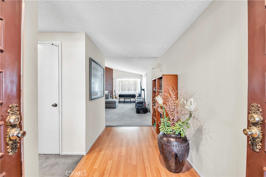1114 Bottle Tree Way Hemet, CA 92545 - Photo 8 of 25 a view of a hallway to a livingroom with furniture