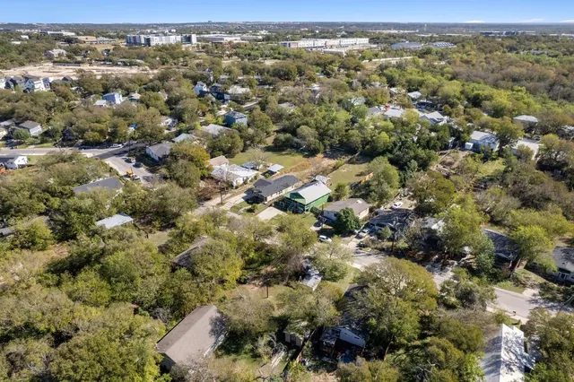 an aerial view of a houses with a yard