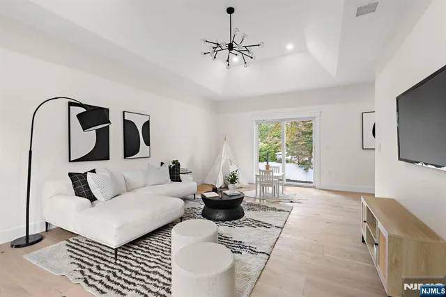 a living room with furniture a large window and a flat screen tv