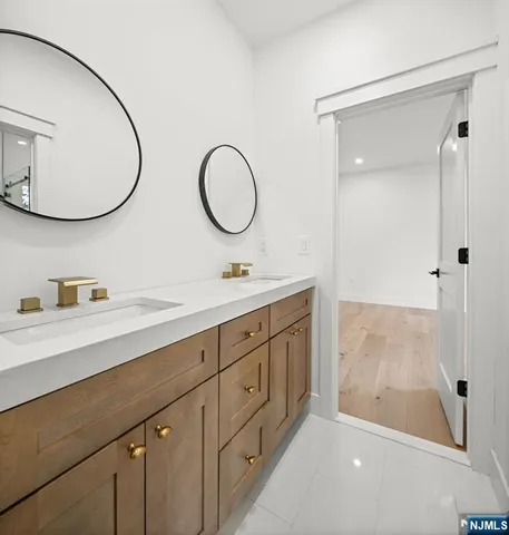 a bathroom with a double vanity sink and a mirror