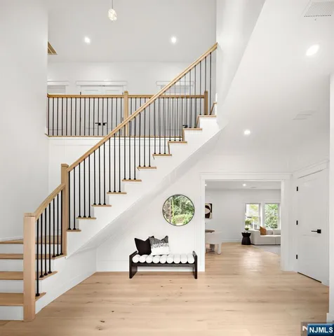 a view of entryway and hall with wooden floor