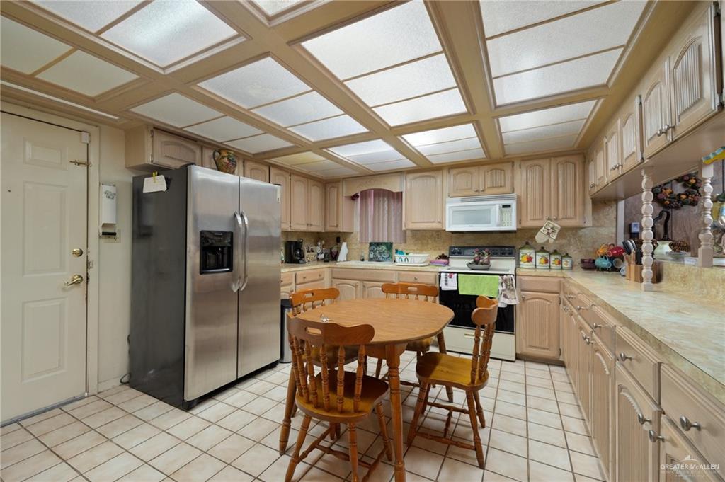 705 Garcia Street Roma, TX 78584 - Photo 8 of 23 a kitchen with stainless steel appliances granite countertop a refrigerator and a stove top oven