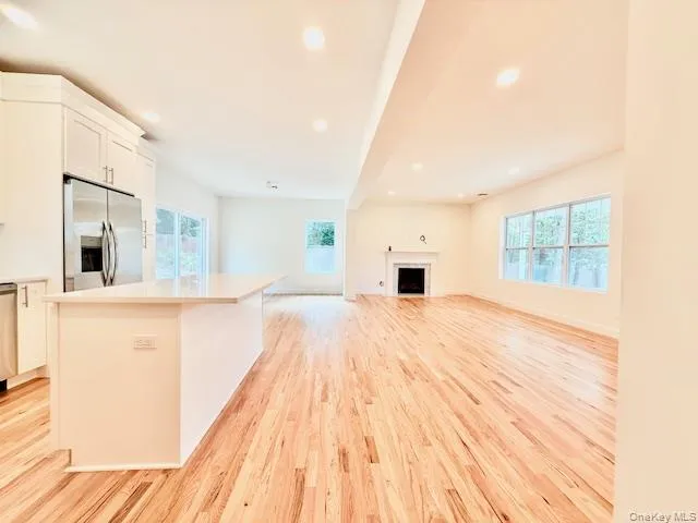 a view of kitchen with granite countertop cabinets and wooden floor
