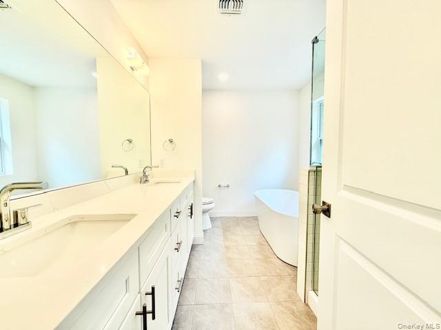 120 River Road Shirley, NY 11967 - Photo 23 of 27 a spacious bathroom with a tub sink and toilet