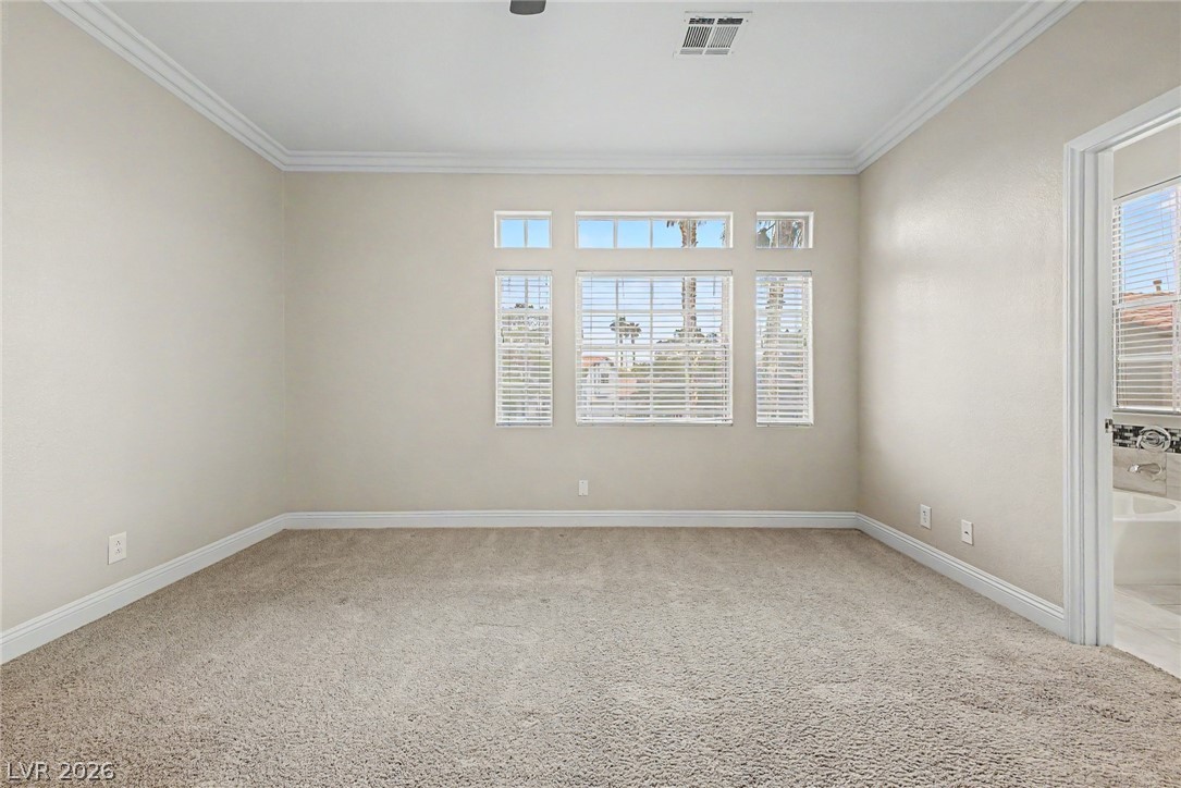 2316 Ramsgate Drive Henderson, NV 89074 - Photo 19 of 28 Well-lit room with generous natural light and soft carpeting, offering comfort and style.