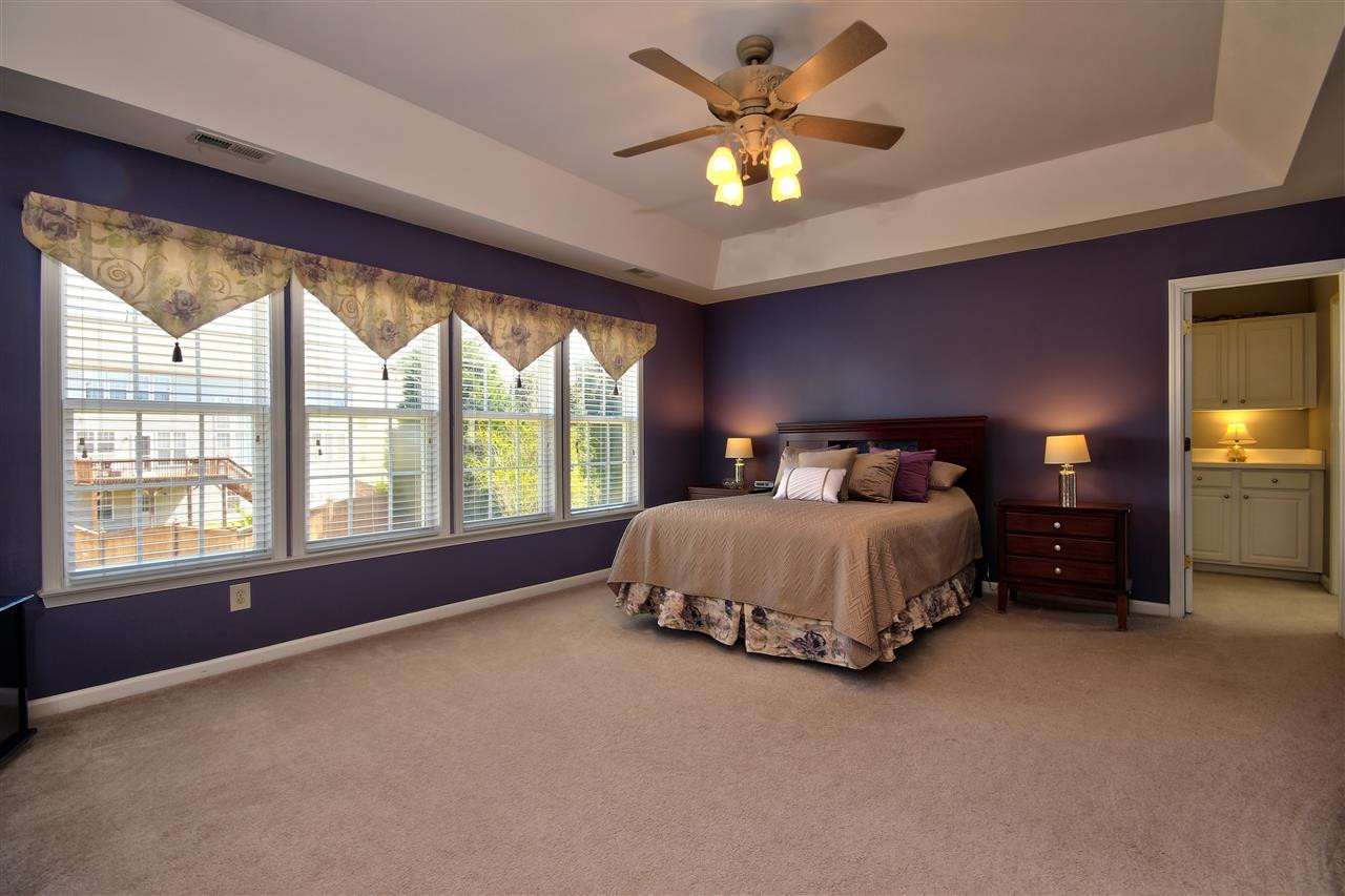 7616 Derek Drive Raleigh, NC 27613 - Photo 12 of 25 SPACIOUS master bedroom features a tray ceiling and ample windows along with a ceiling fan! Master Bedroom