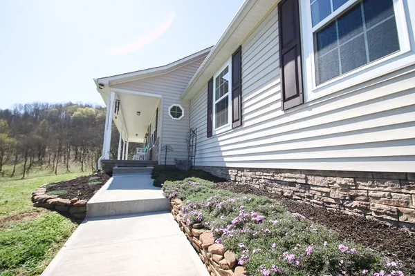 a front view of house with yard and mountain