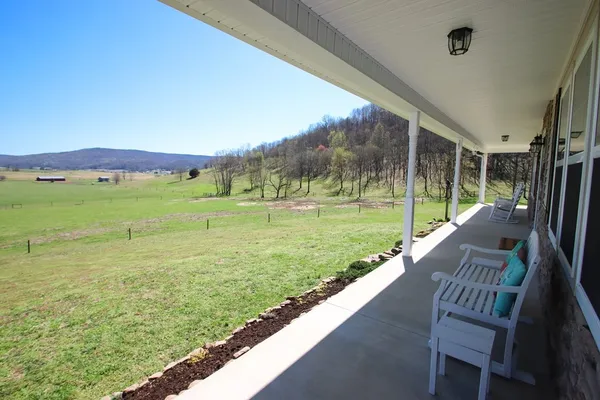 a view of house with backyard porch and garden