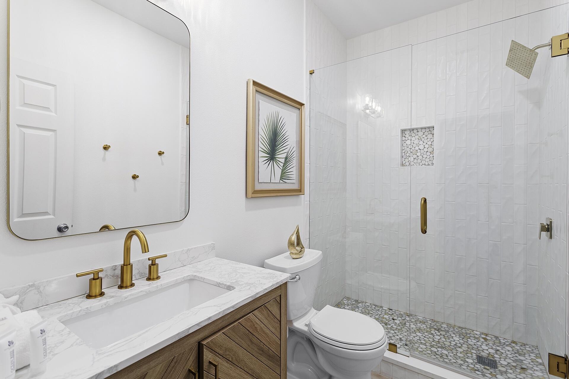 53 Gulfside Way Miramar Beach, FL 32550 - Photo 17 of 34 a bathroom with a granite countertop sink a toilet and a mirror