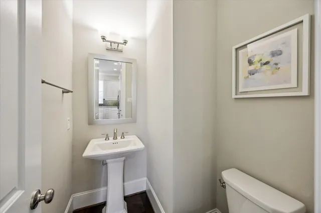 a kitchen with granite countertop a sink stainless steel appliances and white cabinets
