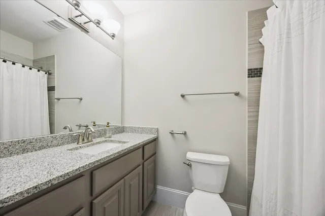 a bedroom with a bed wooden floor and window
