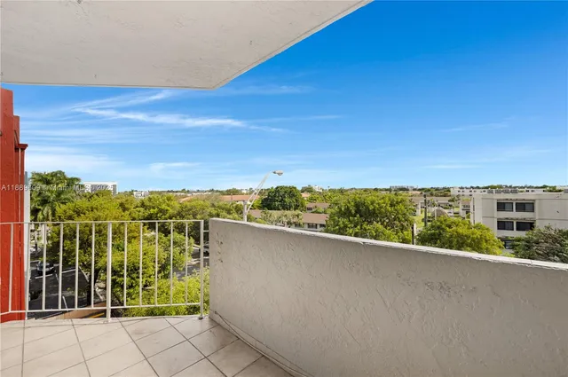 a view of a balcony with an outdoor seating