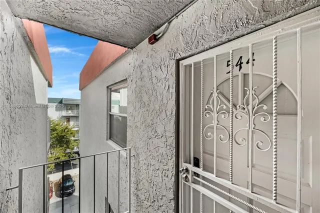 a balcony with table and chairs