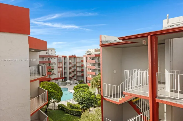 a view of building with swimming pool and outdoor space