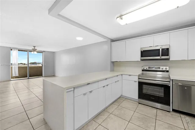 a kitchen with granite countertop a sink and steel appliances