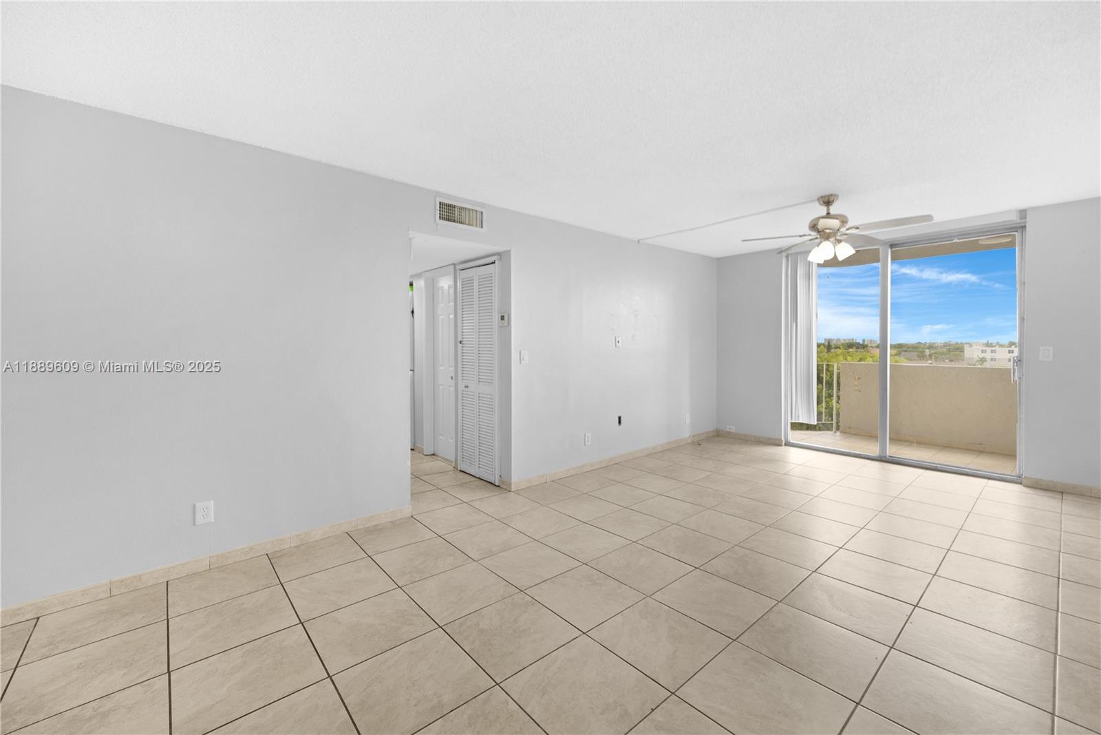 1750 West 46th Street, Unit 544 Hialeah, FL 33012 - Photo 10 of 46 a view of an empty room and window & cabinet door