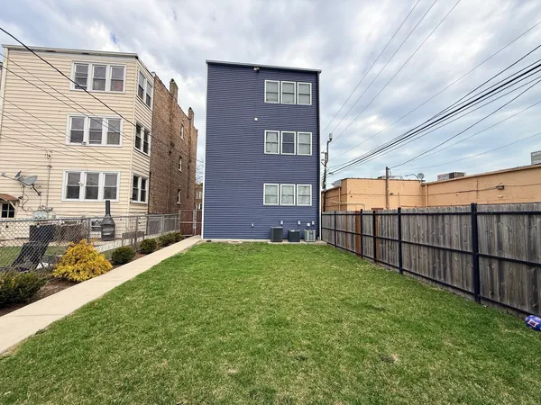 a view of a brick house with a yard