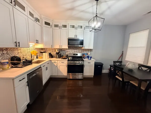 a kitchen with a stove window and cabinets