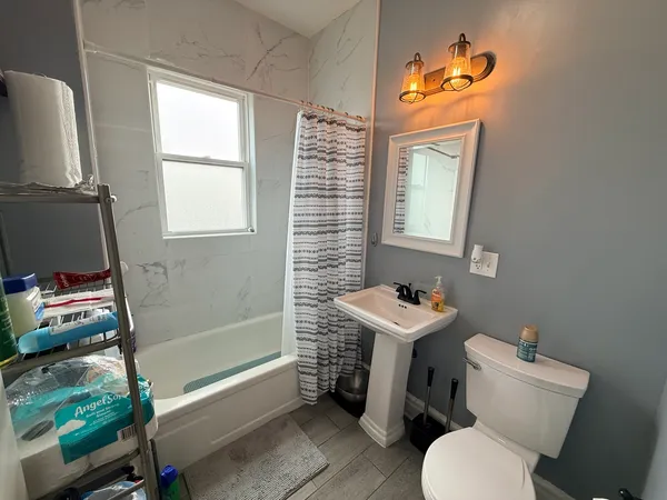 a bathroom with a sink mirror vanity and toilet