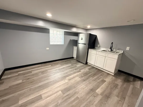a kitchen with stainless steel appliances kitchen island a refrigerator sink and cabinets