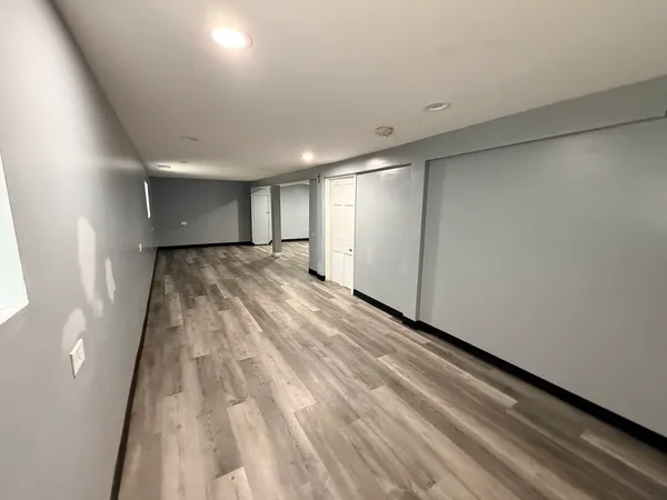 a view of a room with wooden floor