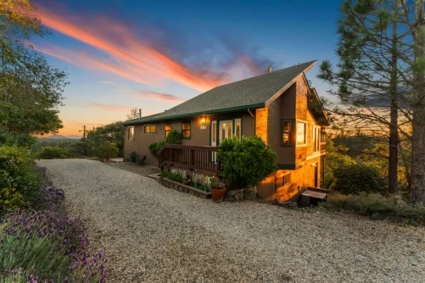 a view of backyard with a garden and deck
