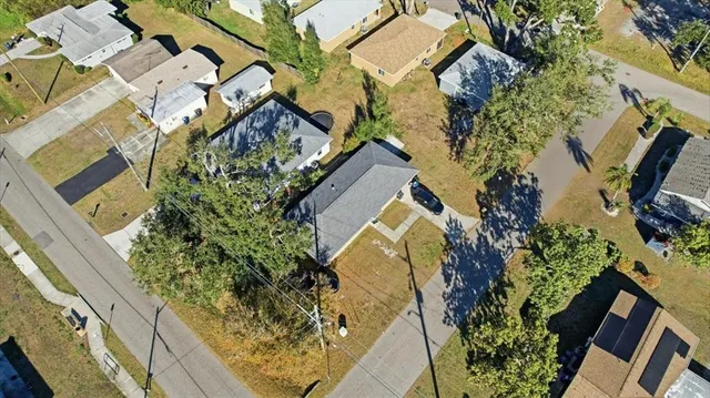 an aerial view of a house with a yard