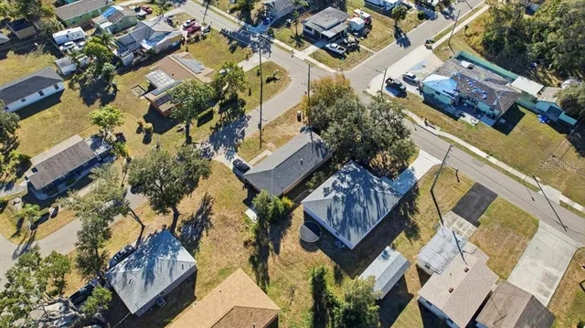 an aerial view of a house with a yard and outdoor seating