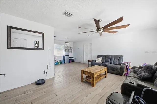a bedroom with furniture and a wooden floor